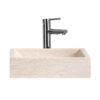 Lavabo Haumea de estilo contemporáneo fabricado en piedra en color marfil.