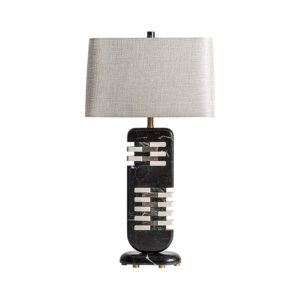 Lámpara de sobremesa Carla de estilo art deco fabricado en mármol en color negro combinado con metal en color dorado y poliéster en color arena con acabado jaspeado. Producto desmontable.